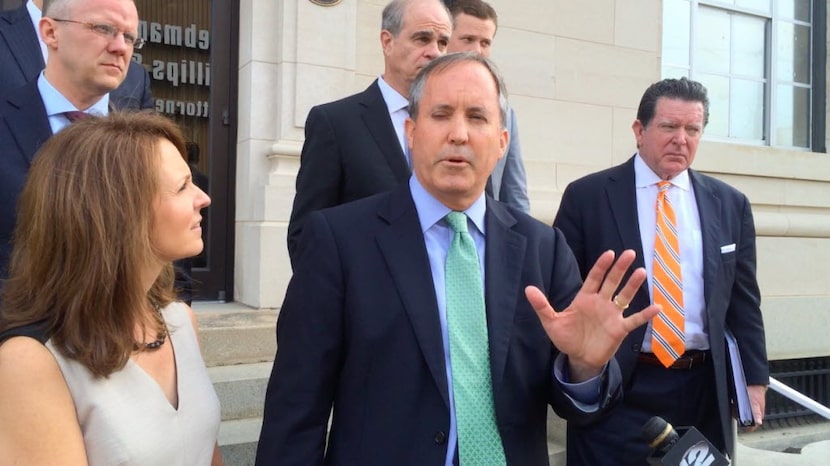 Surrounded by his wife and lawyers, Texas Attorney General Ken Paxton speaks on Friday,...