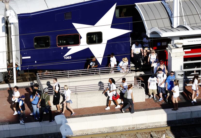 Parade goers spill off the Trinity Railway Express (TRE) train at Union Station in Dallas.