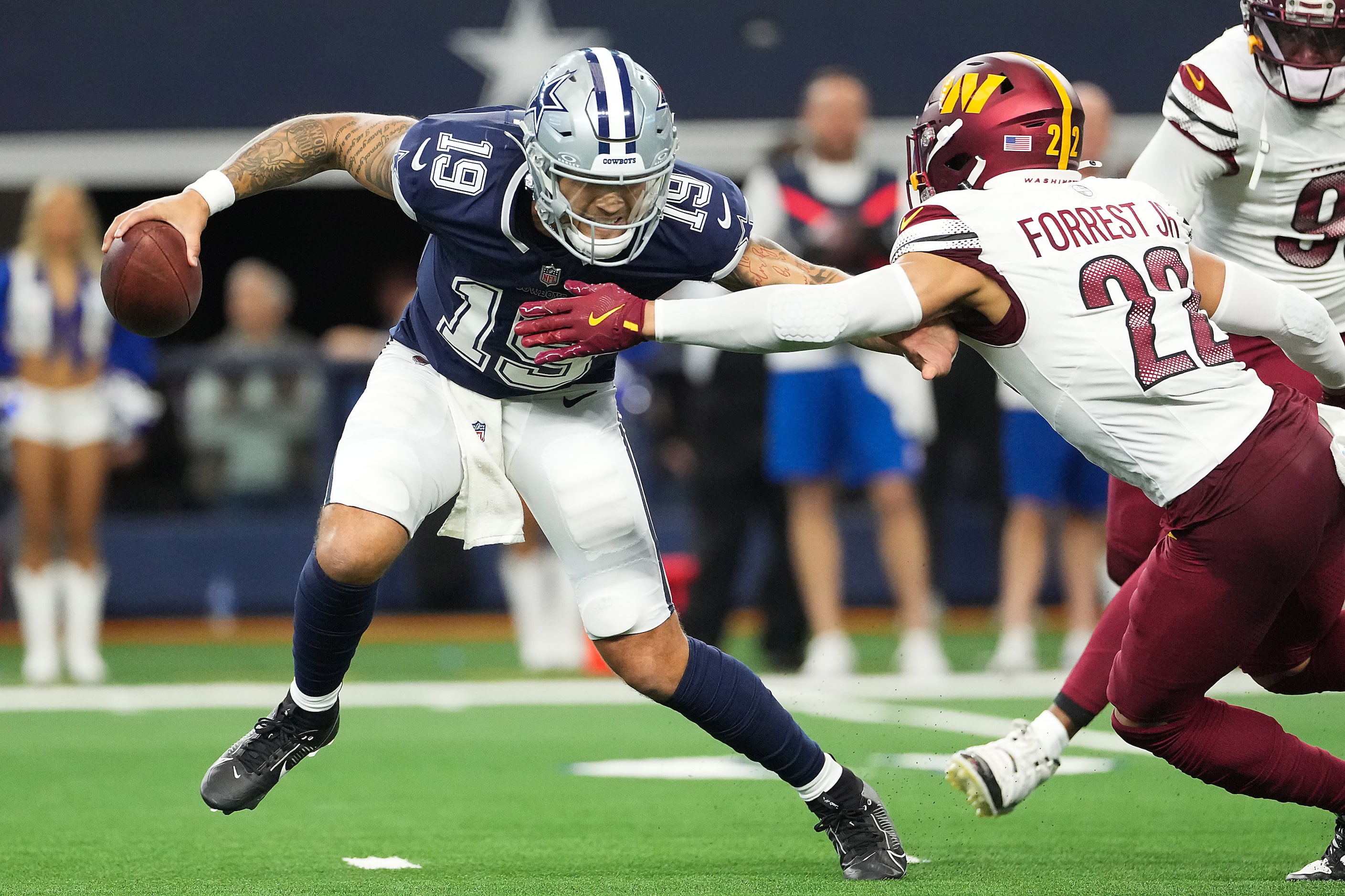 Dallas Cowboys quarterback Trey Lance (19) is chased down by Washington Commanders safety...