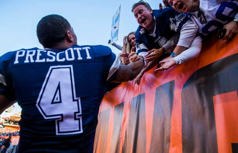 Dallas Cowboys quarterback Dak Prescott (4) celebrates with fans after the Cowboys won 35-10...