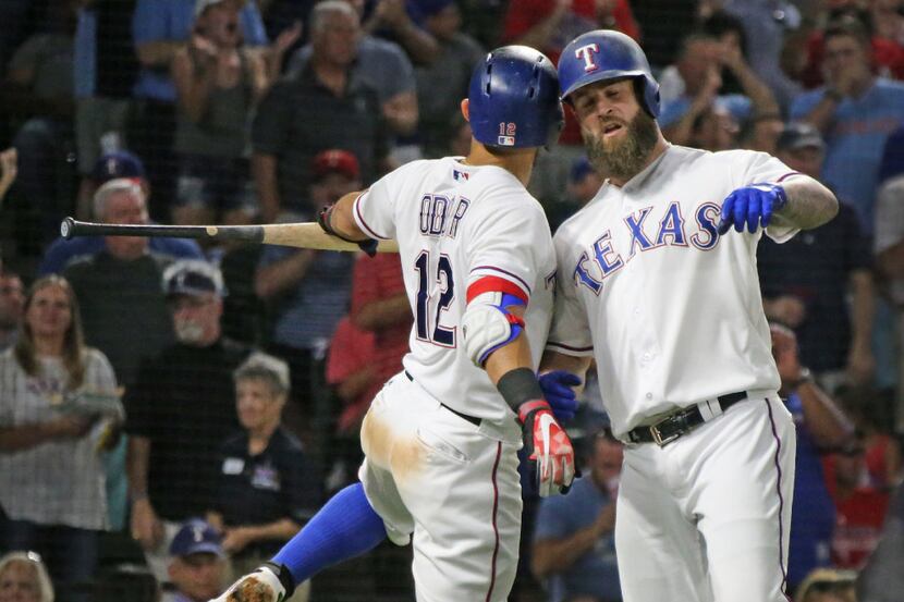 Texas Rangers Rougned Odor (12) and Mike Napoli, right, celebrate Napoli's home run during...
