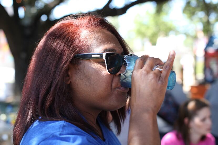 Dawn M. Burkes tries out the State Fair Edible Cola, a cup of Maine Root soda in a...
