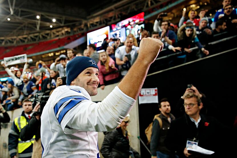 Dallas Cowboys quarterback Tony Romo pumps his fist to cheering fans following Dallas' 31-17...