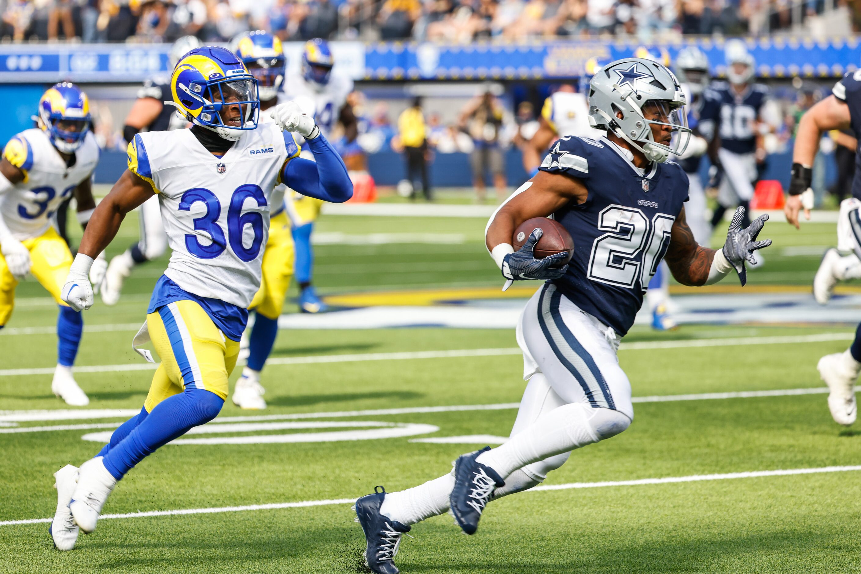 Dallas Cowboys running back Tony Pollard (20) gets past Los Angeles Rams cornerback Grant...