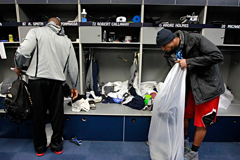 Dallas Cowboys practice squad receiver Andre Holmes joins other players in cleaning out...