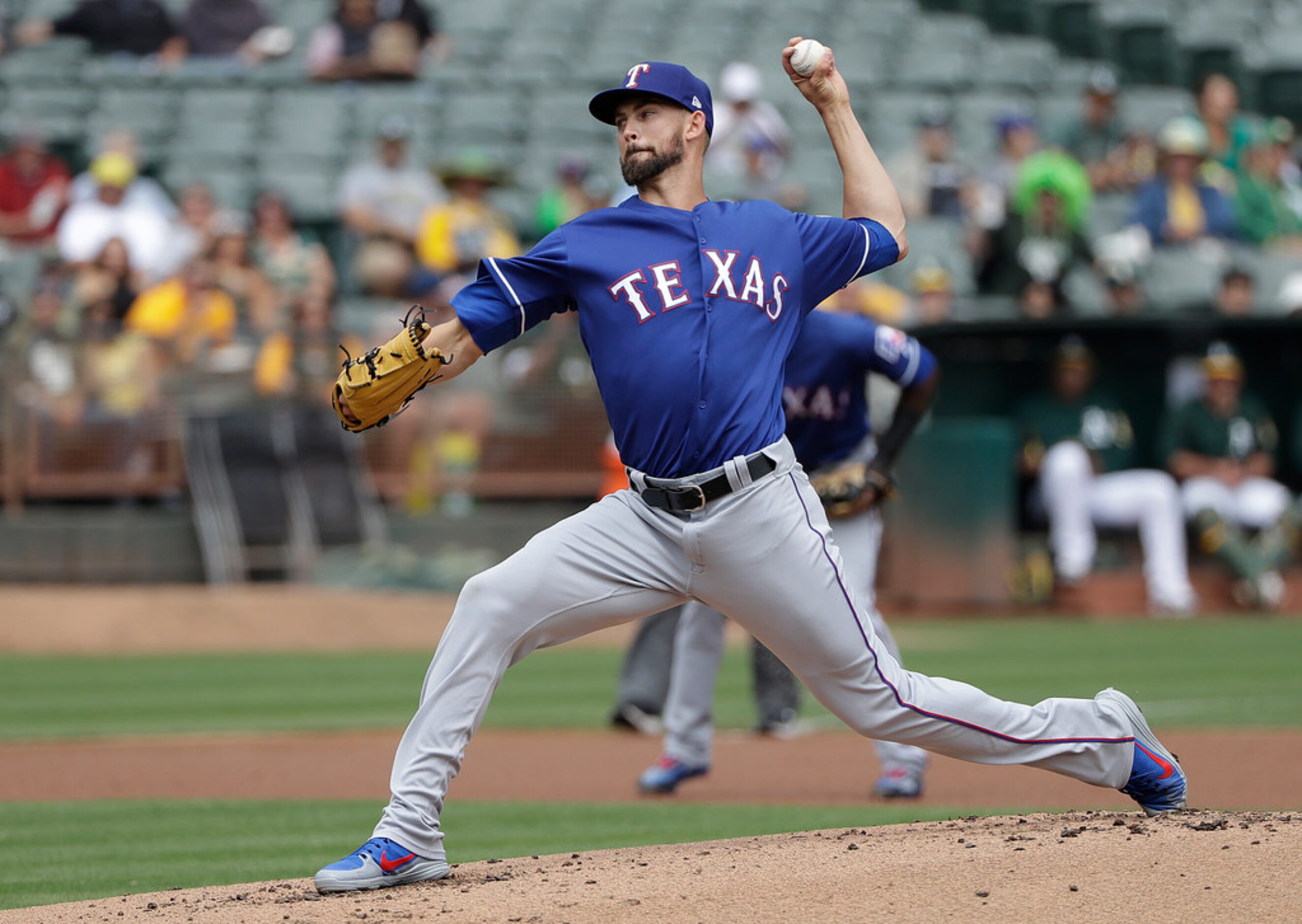 Texas Rangers pitcher Mike Minor throws against the Oakland Athletics during the first...