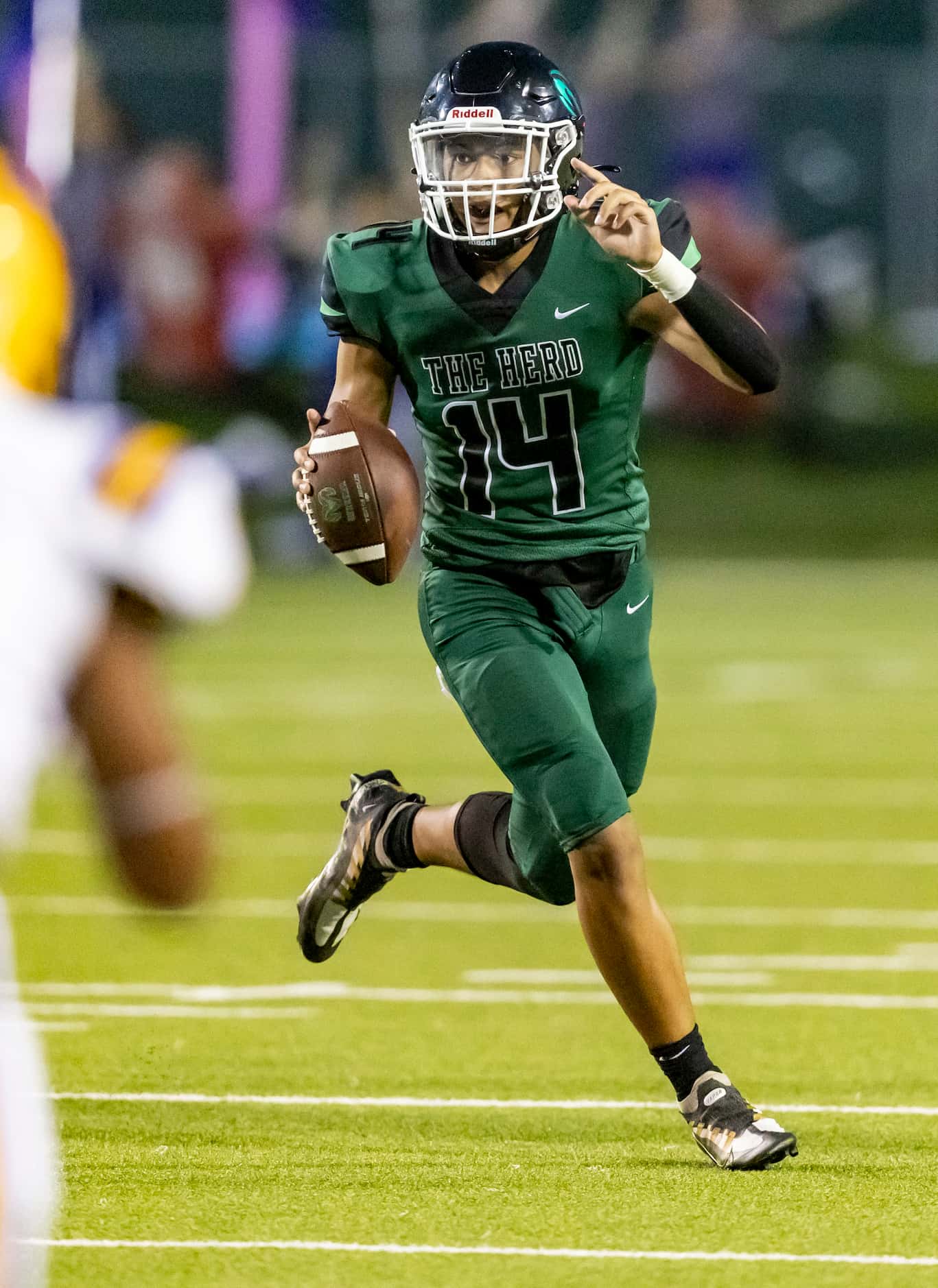 Berkner sophomore quarterback Cornell McGee IV (14) signals to a teammate during the first...