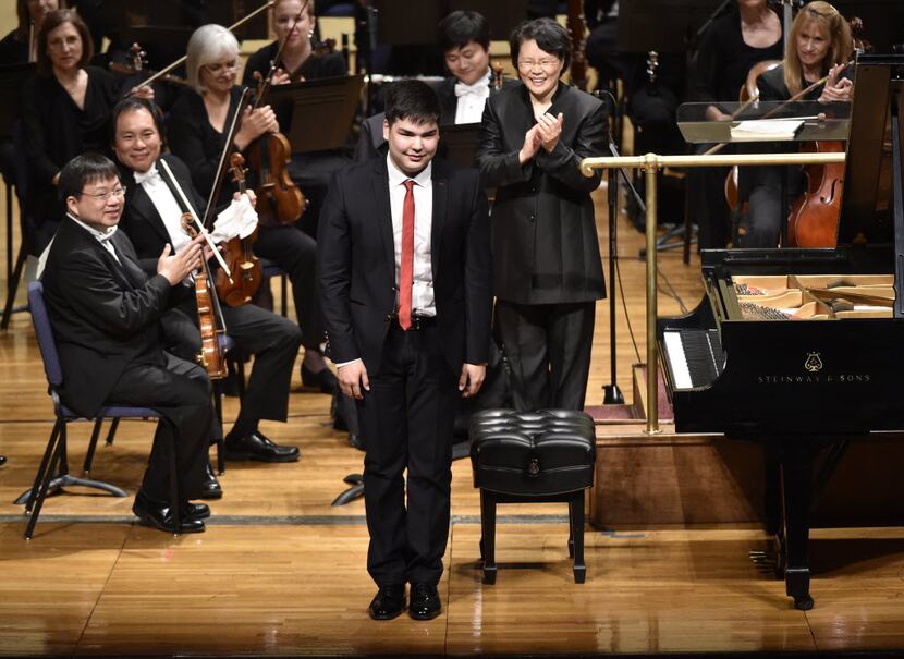 Alim Beisembayev, of Kazakhstan, bows to the crowd after playing Tchaikovsky's Piano...