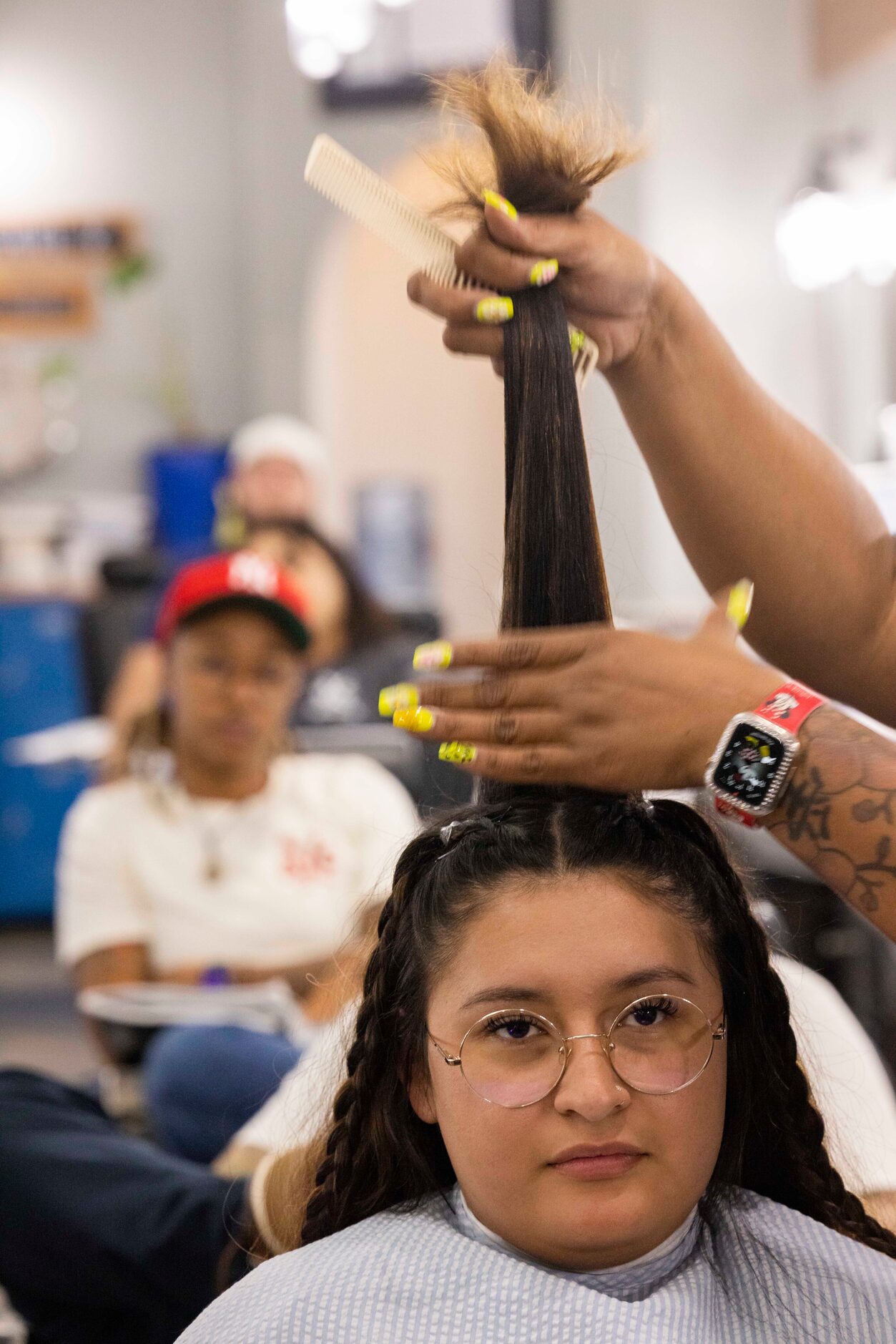 Instructor Kathia Santana demonstrates how layering works while using student Cynthia...