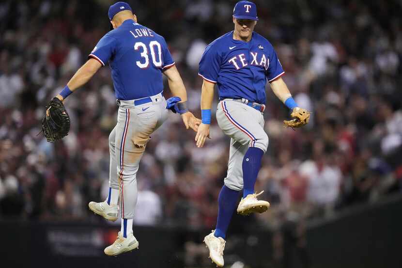 Texas Rangers first baseman Nathaniel Lowe (30) and third baseman Josh Jung (6) celebrate a...