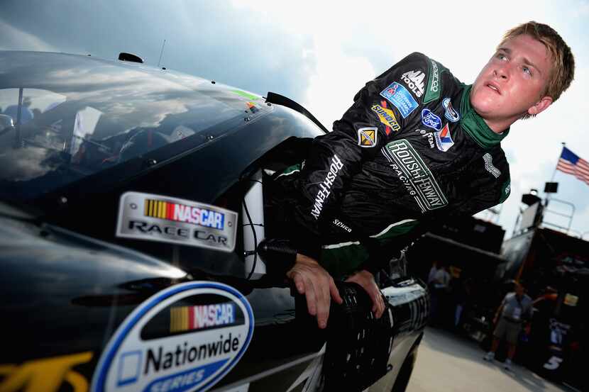 Chris Buescher, driver of the #16 Roush Fenway Racing Driven Ford, climbs from his car...