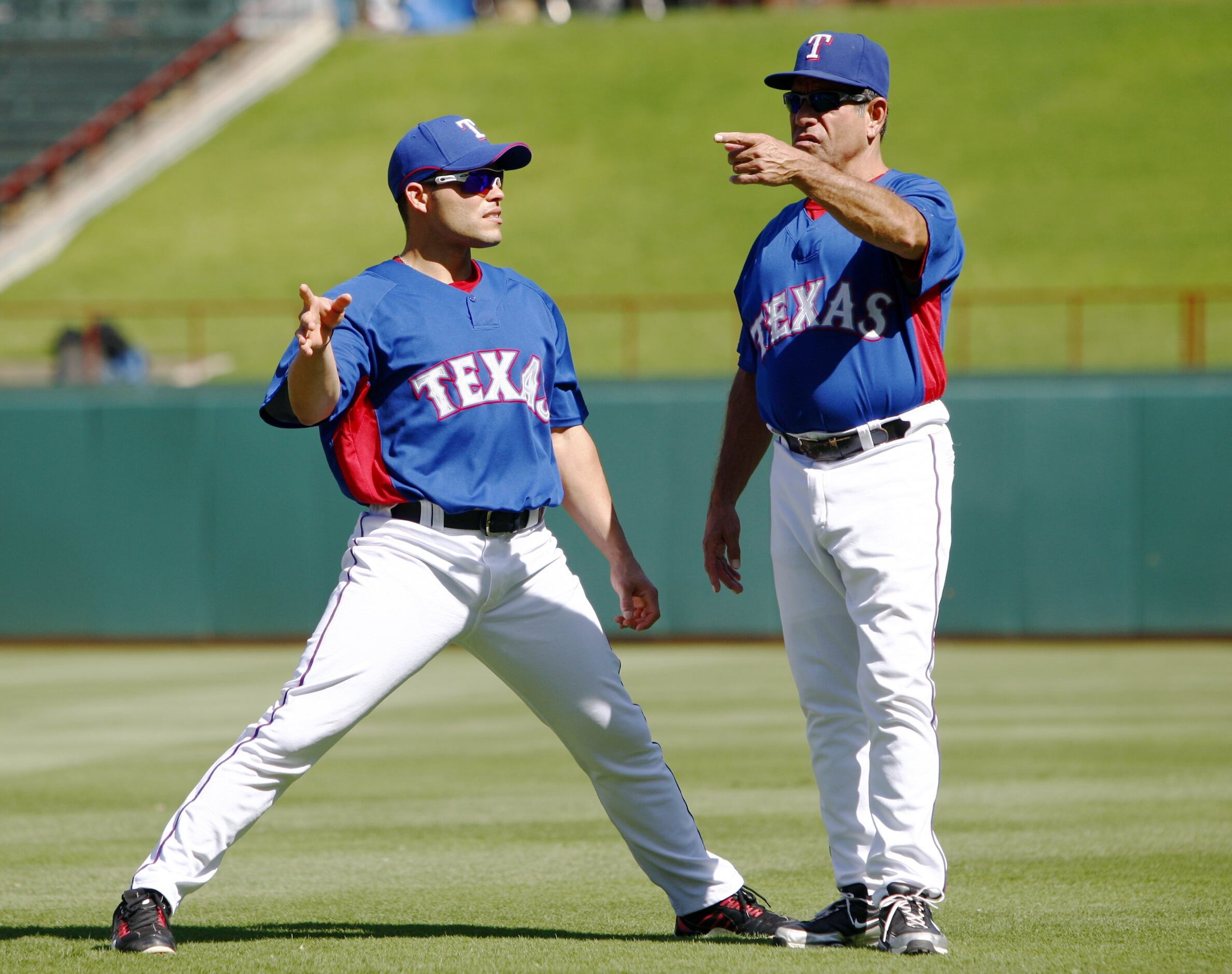 Texas Rangers hitting coach Rudy Jaramillo tips his hat to the crowd after  accepting an award from The Hispanic Heritage Baseball Museum Hall of Fame  before a baseball game against the Los