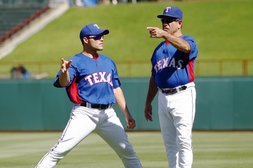 Texas Rangers catcher Ivan "Pudge" Rodriguez (7 - left) talks with Hitting Coach Rudy ...