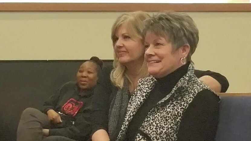 
Vicki Smith, right, and Terri Burnett, middle, laugh during her daughter’s testimony after...