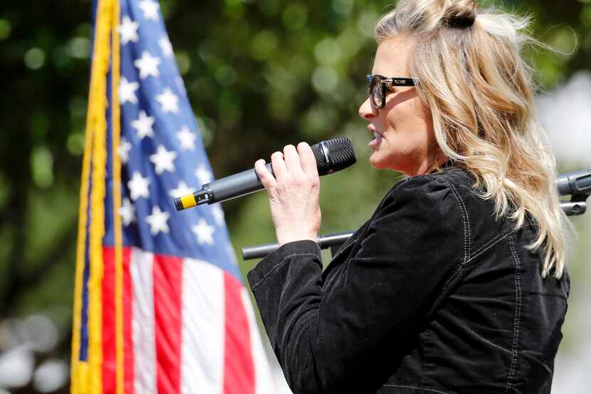Business owner Shelley Luther addresses the crowd during an Open Texas rally outside Frisco...