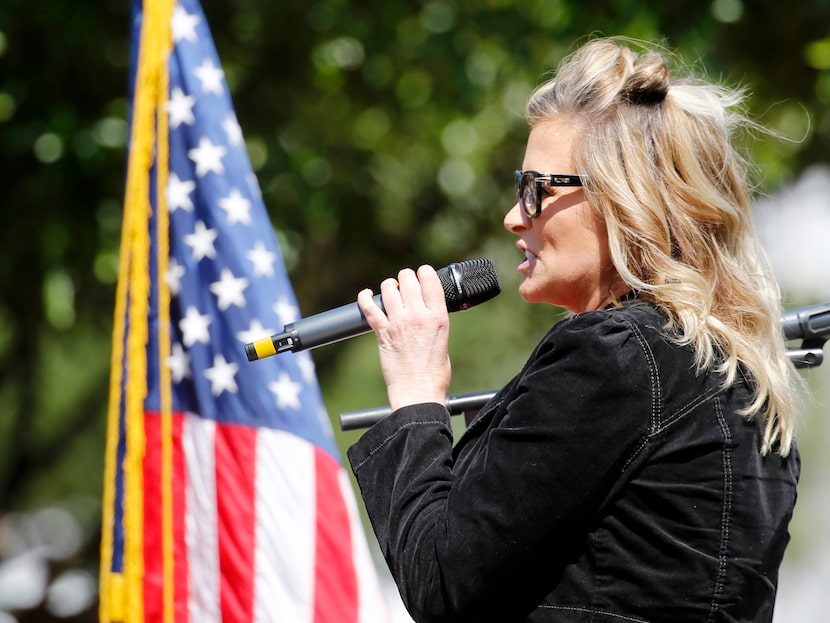 Business owner Shelley Luther addresses the crowd during an Open Texas rally outside Frisco...