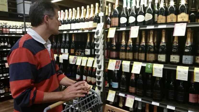 
Adrian Bird of Coppell shops for sparkling wine at Total Wine and More in Lewisville. The...