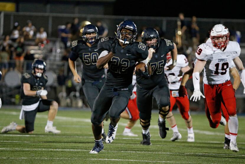 Jesuit's Evan Jackson (22) runs in a touchdown against Coppell during the second half at...