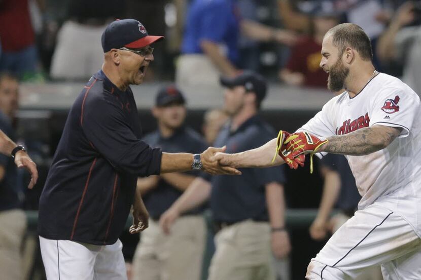 Cleveland Indians manager Terry Francona, left, congratulates Mike Napoli after Napoli hit a...