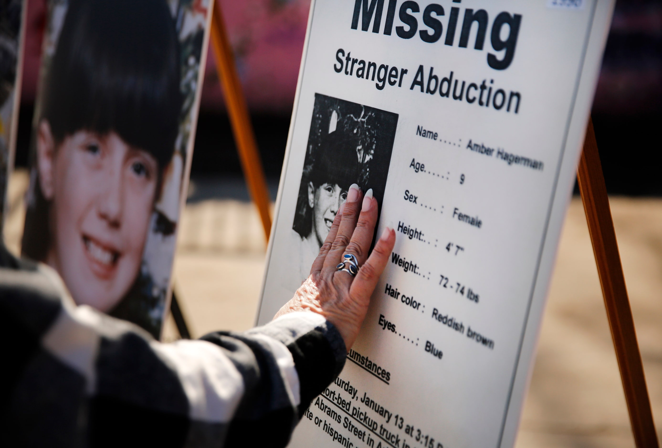 Amber Hagerman's mother Donna Williams touches a photo of her daughter on the original...