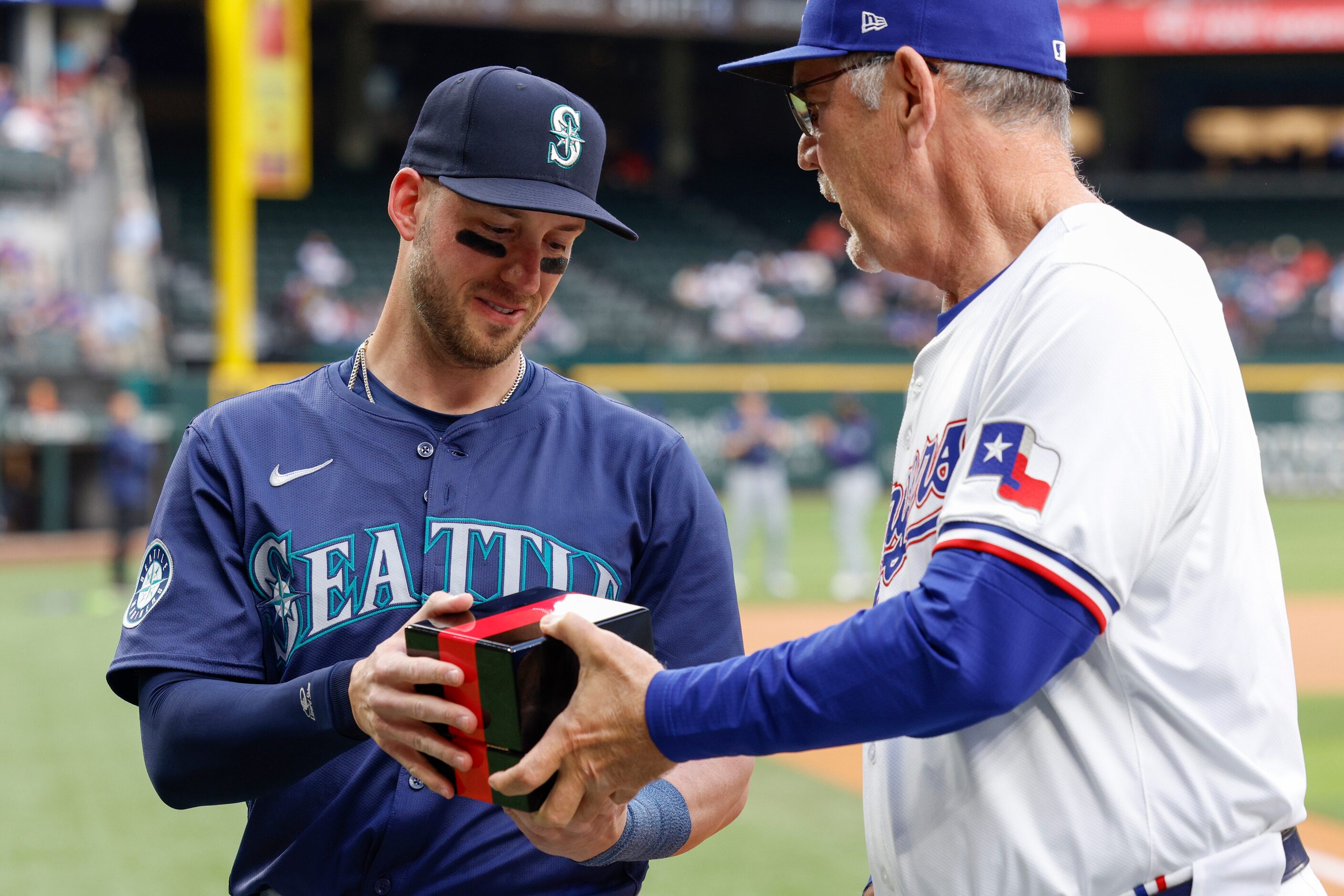 Texas Rangers manager Bruce Bochy presents former Rangers catcher Mitch Garver with his 2023...