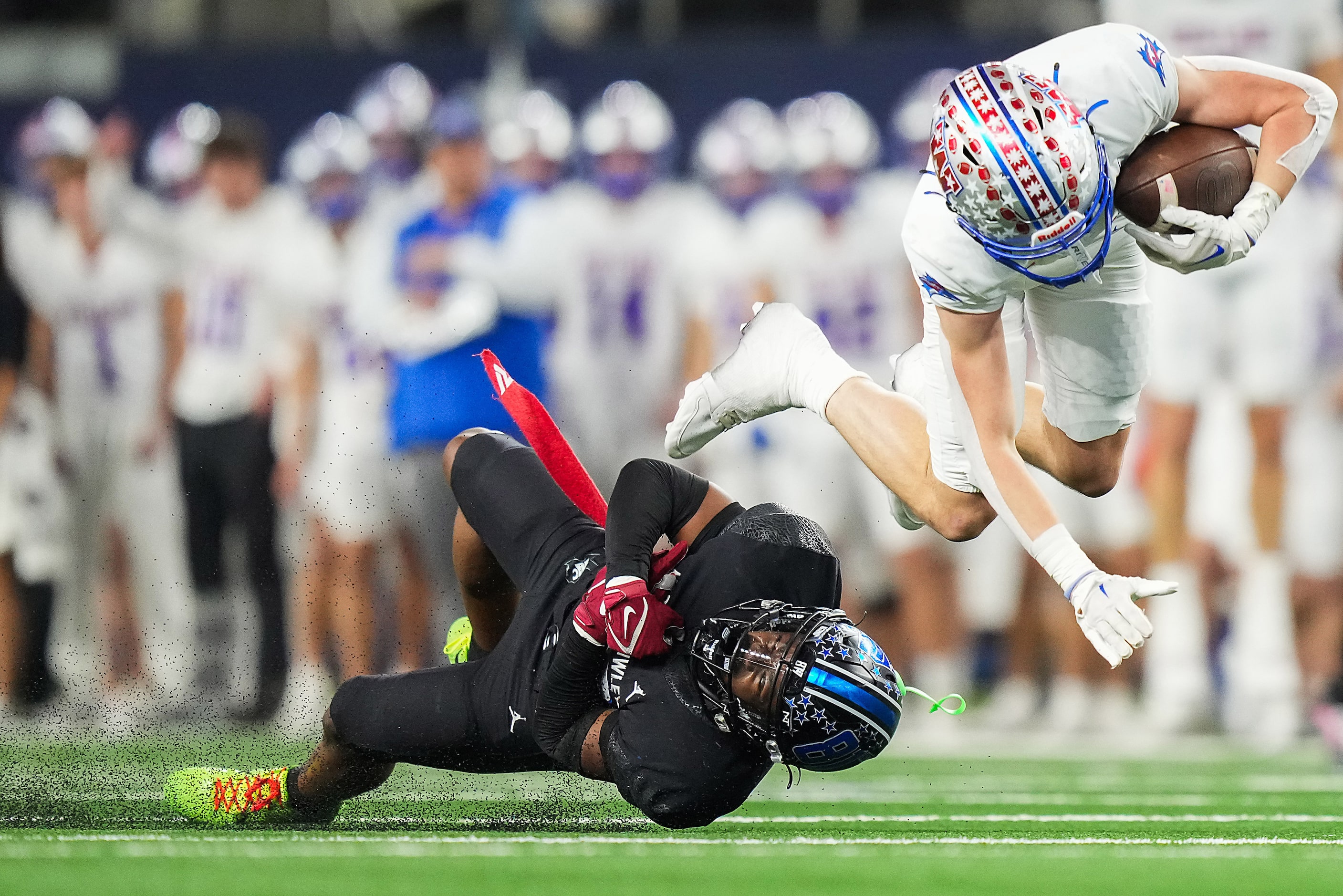 Austin Westlake wide receiver Chase Bowen (11) is tripped up by North Crowley defensive back...