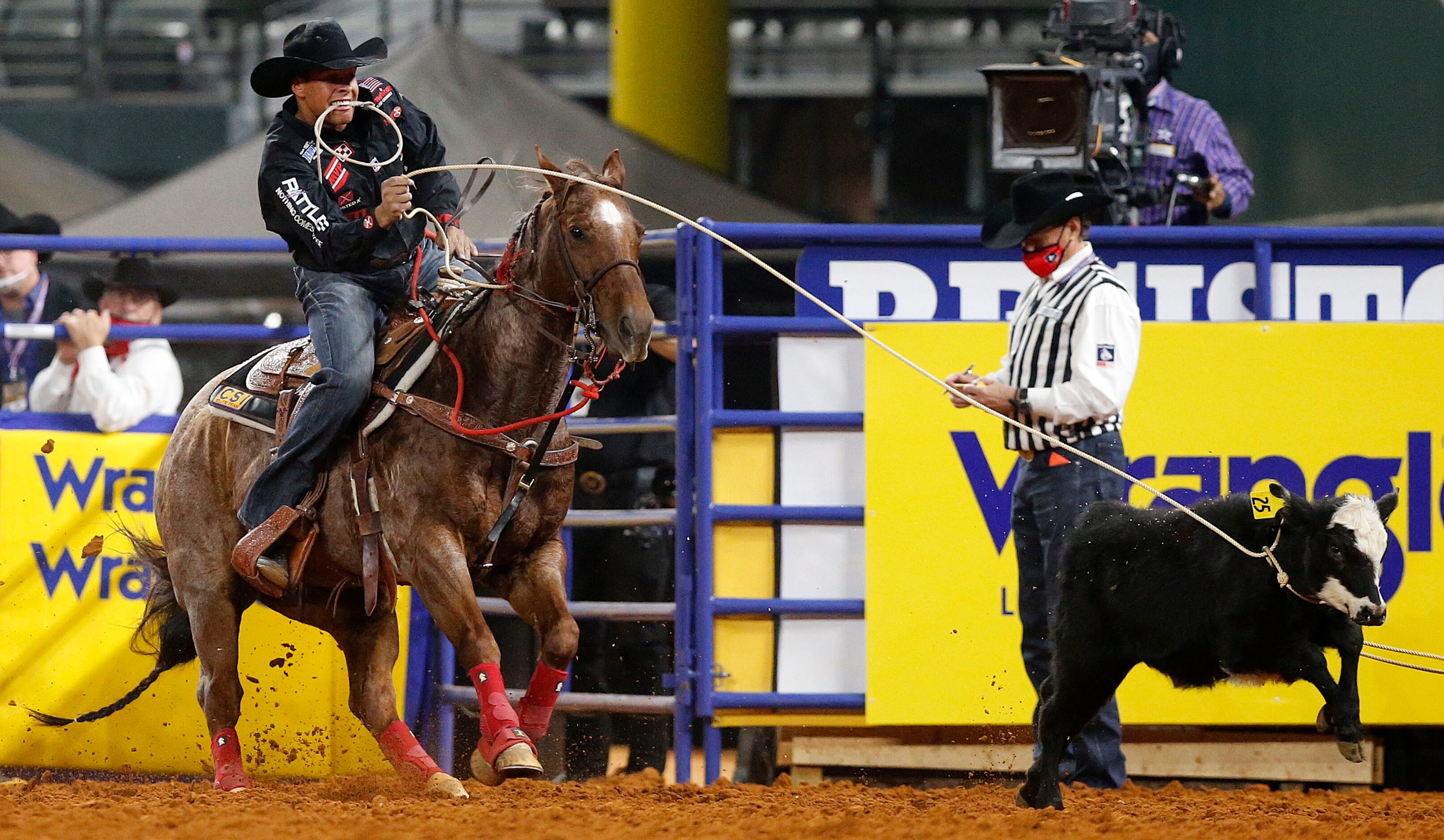 Tie-Down Roping World Champion Shad Mayfield of Clovis, New Mexico lassoes a calf as he...