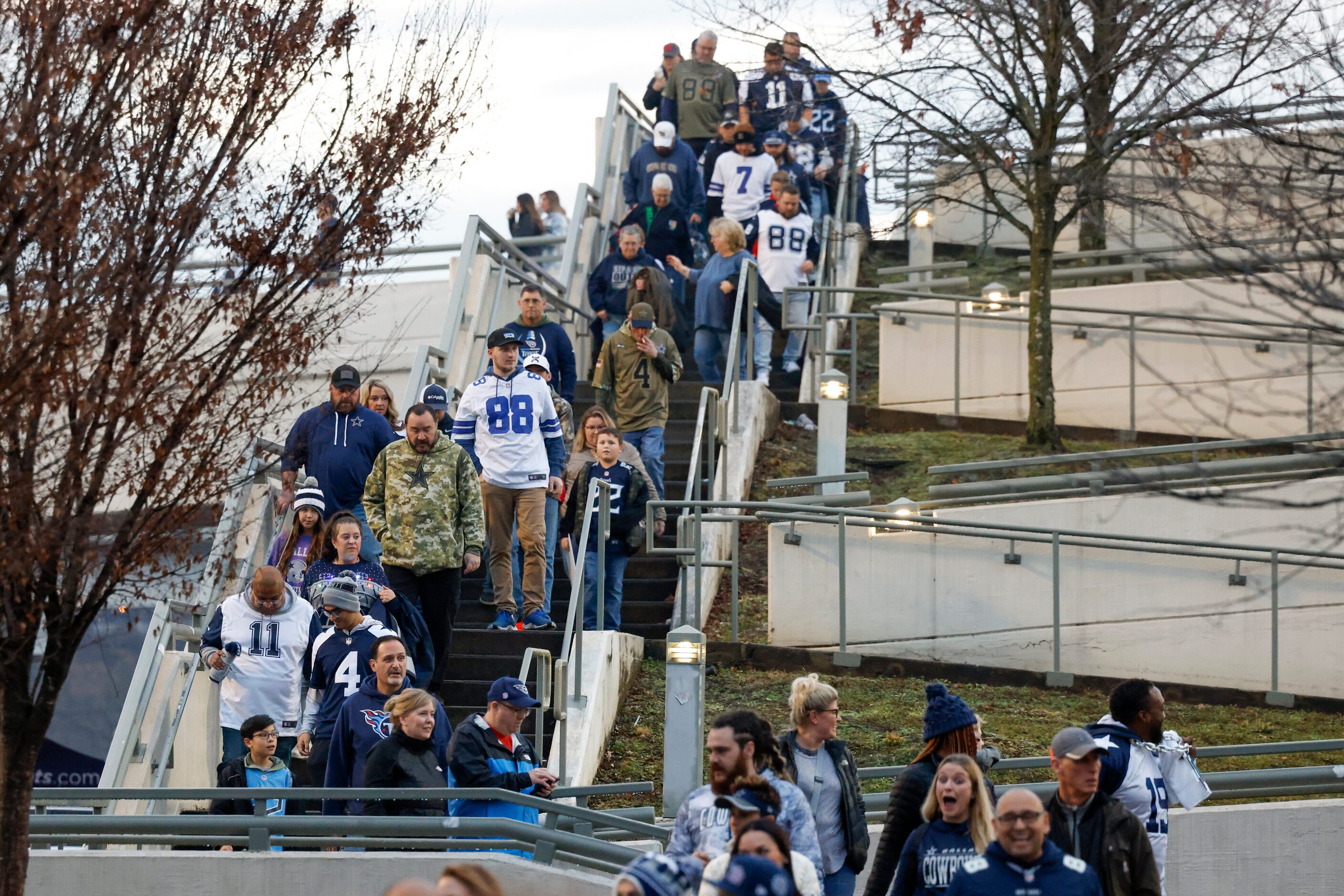 A number of Dallas Cowboys fans make their way before an NFL game against the Tennessee...