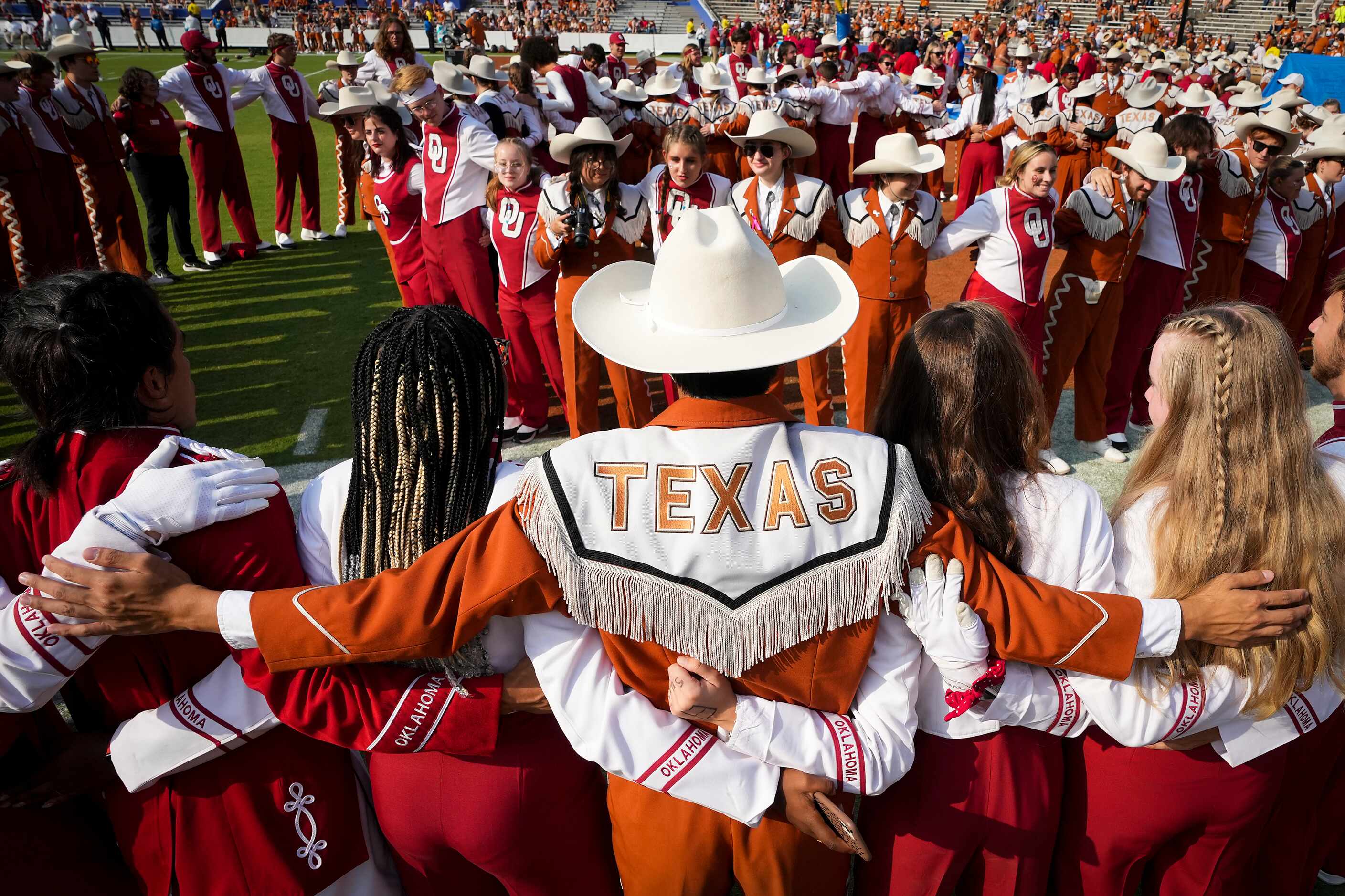 Texas  and Oklahoma  band members lock arms before the annual Red River Showdown football...