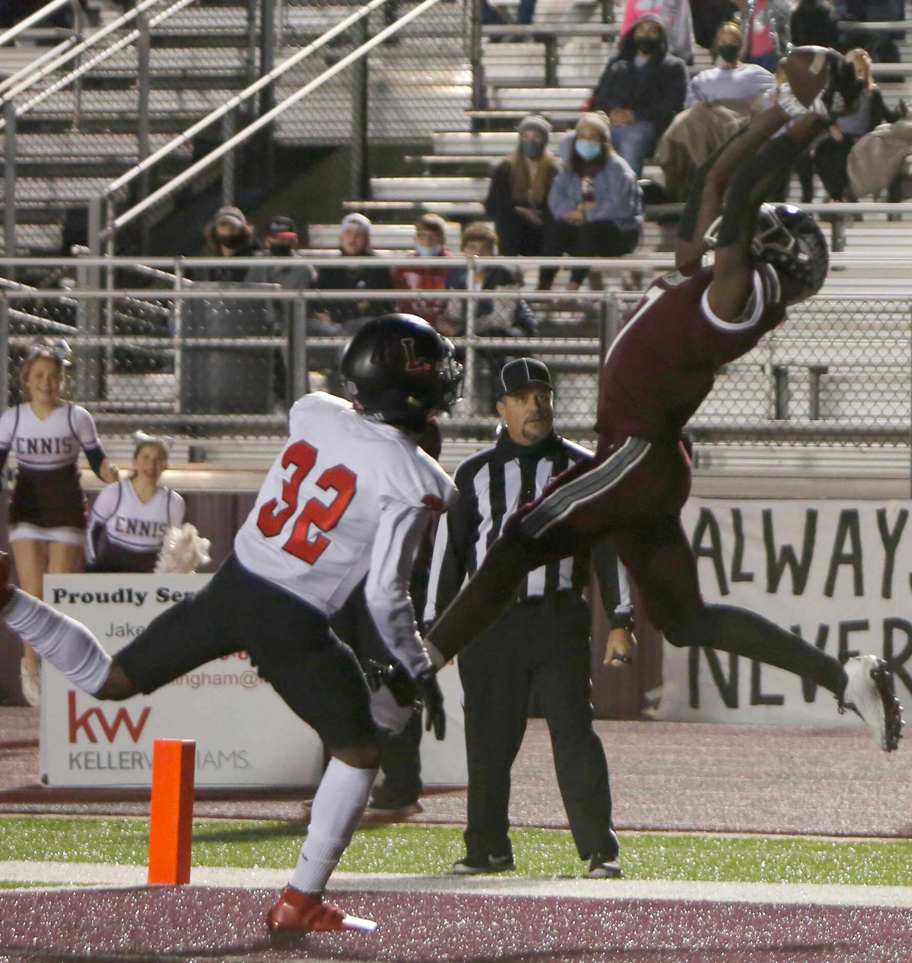 Ennis receiver Laylon Spencer (7) leaps to pull in a receiving touchdown against the defense...