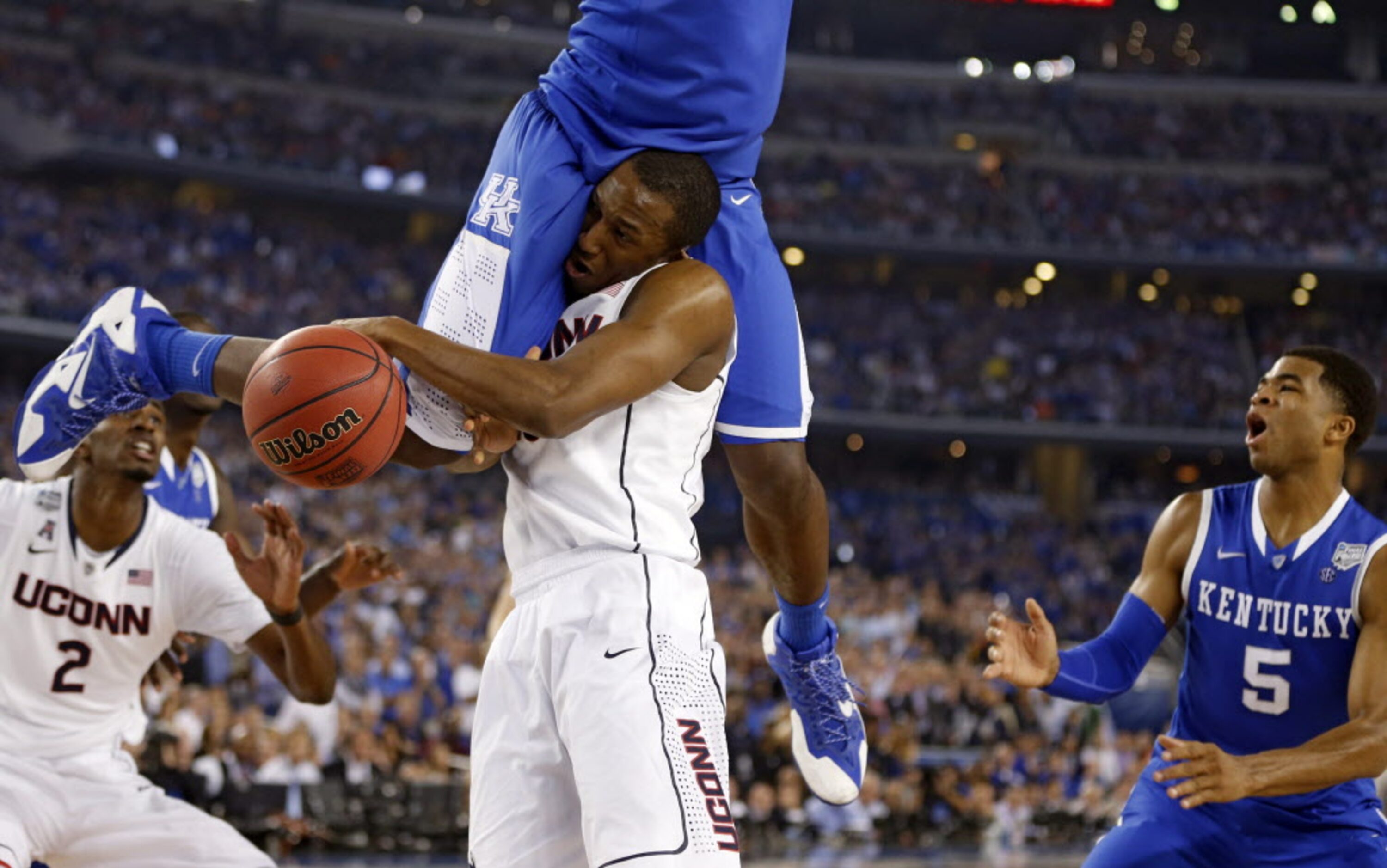 Connecticut Huskies guard/forward Lasan Kromah (20) is fouled by Kentucky Wildcats forward...