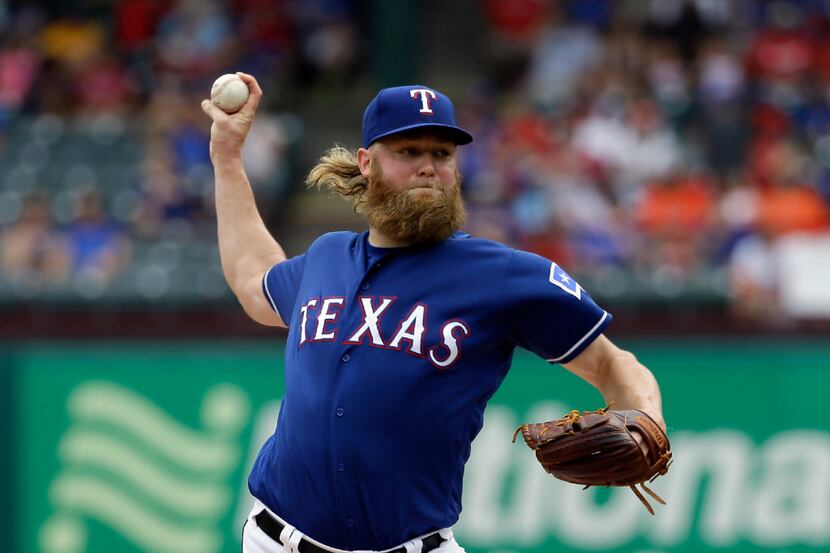 Texas Rangers starting pitcher Andrew Cashner throws to the Houston Astros in the first...