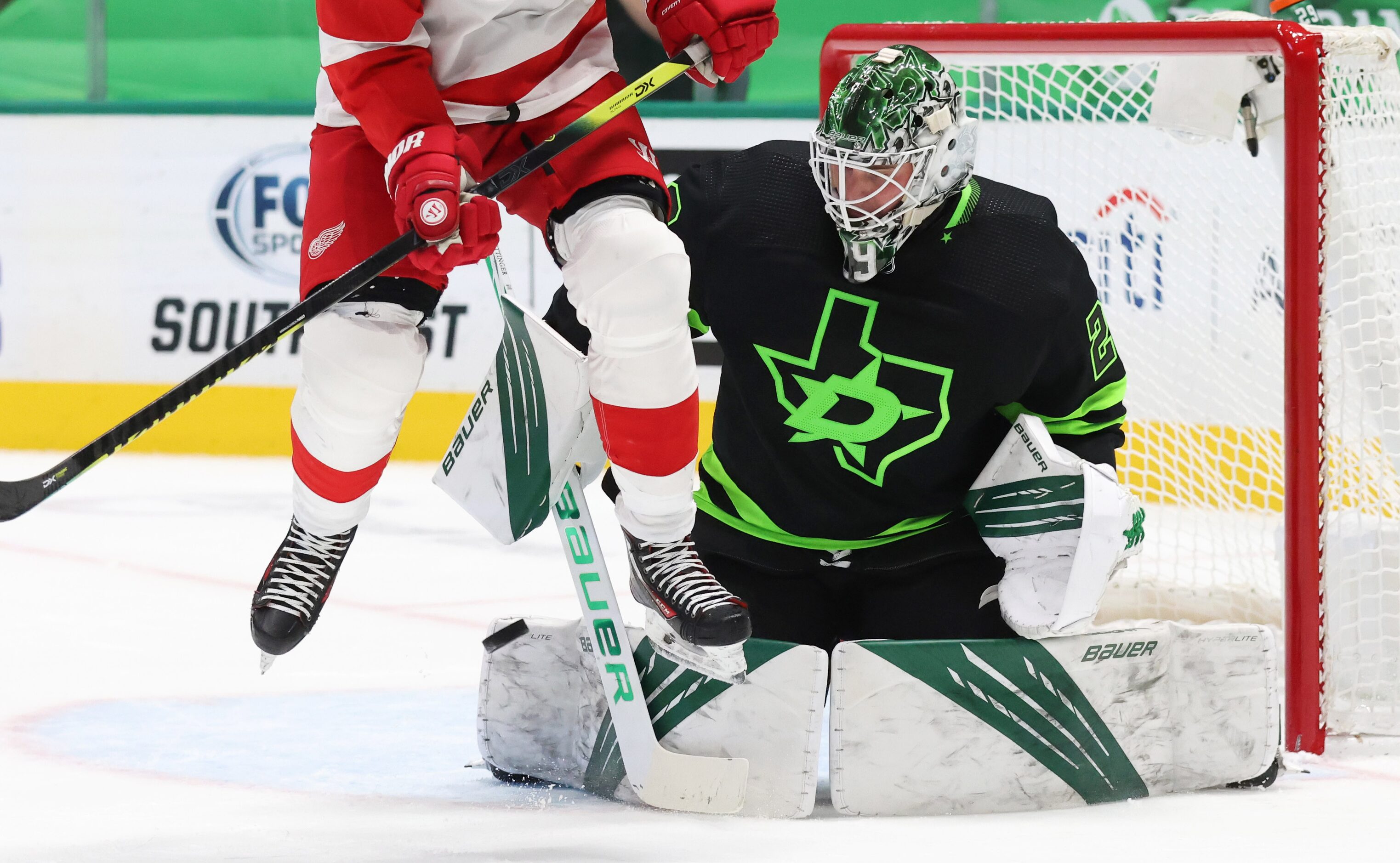 Dallas Stars goaltender Jake Oettinger (29) stops a shot on goal as Detroit Red Wings right...