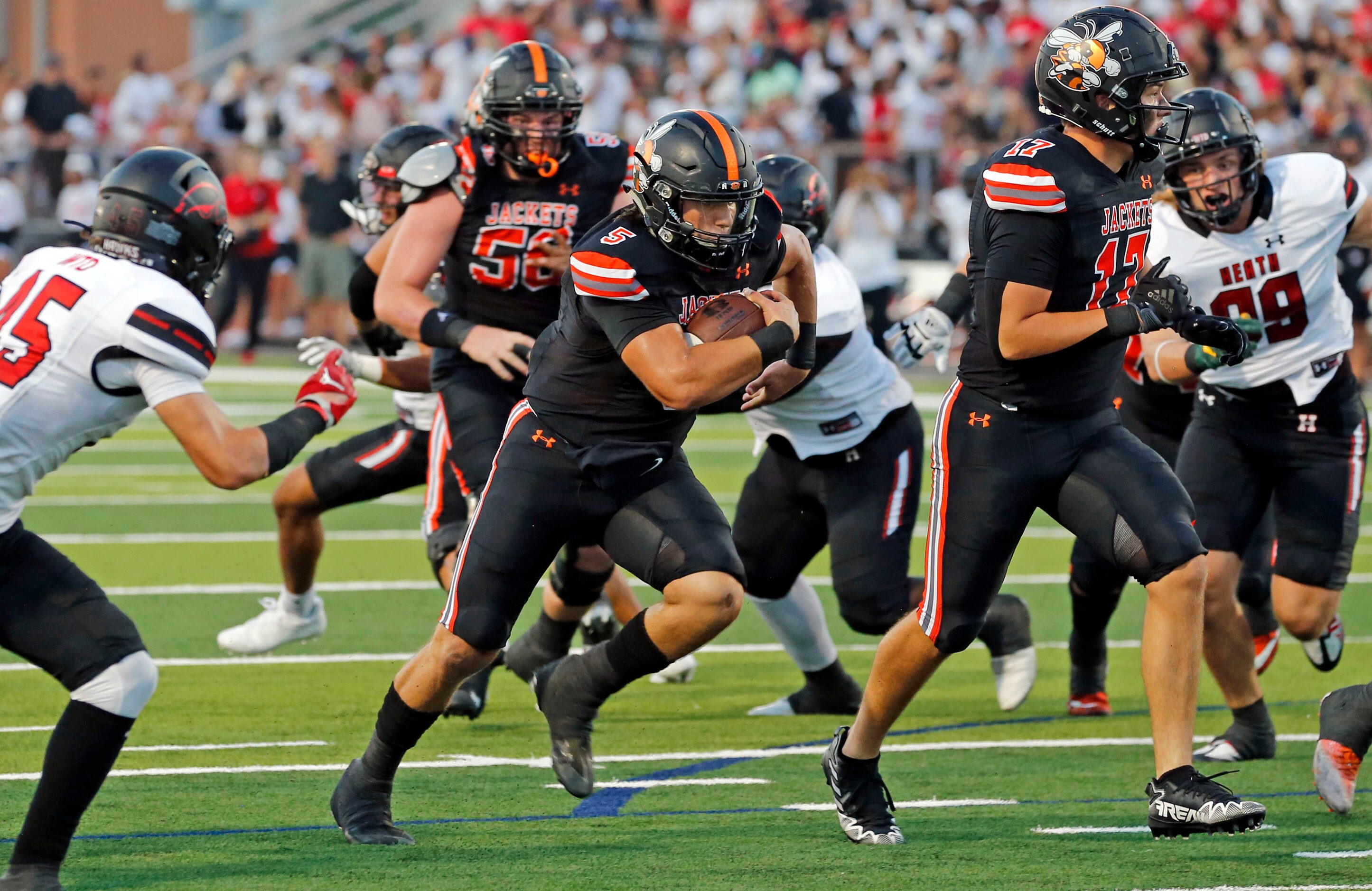 Rockwall high QB Lake Bennett (5) finds a seam and heads to the end zone for a touchdown...