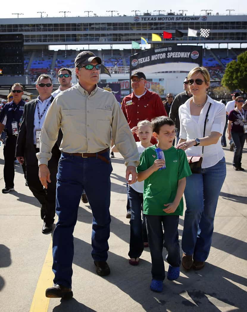 Former governor Rick Perry walks with family at the No Limits Wild Asphalt Circus prior to...