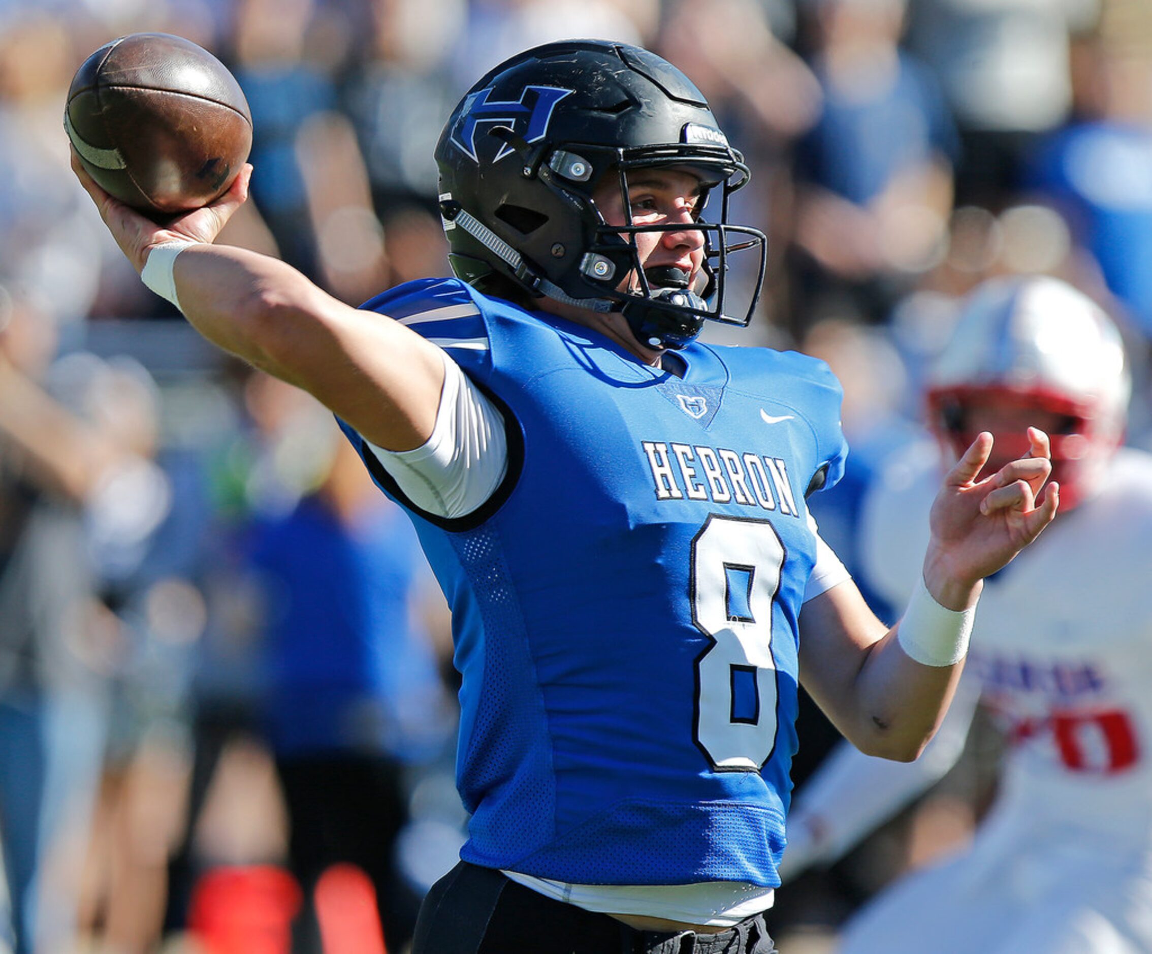 Hebron High School quarterback Carson Harris (8) throws a pass during the first quarter as...