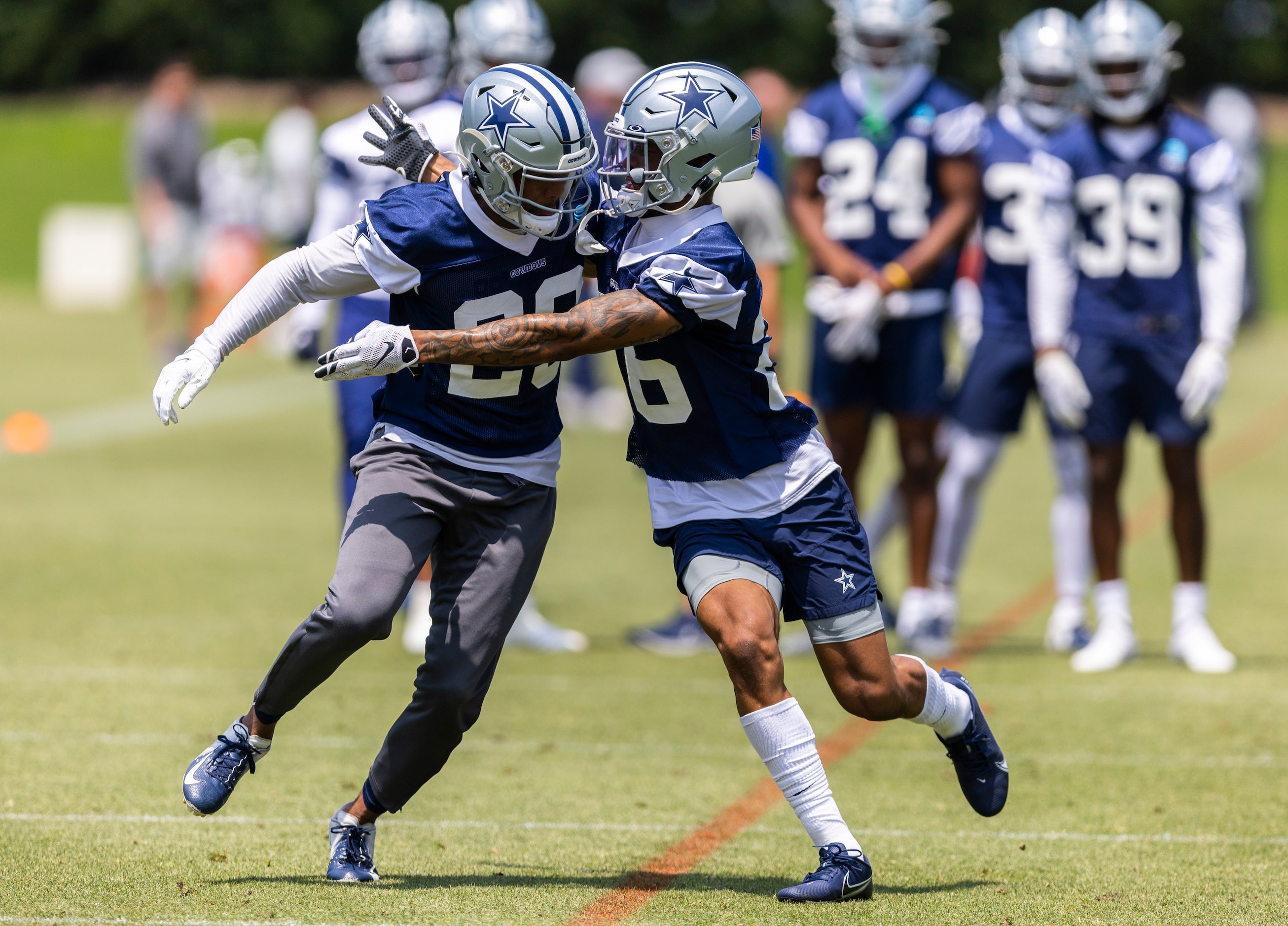 Dallas Cowboys cornerbacks C.J. Goodwin, left, and Kyron Brown, right, run a drill against...