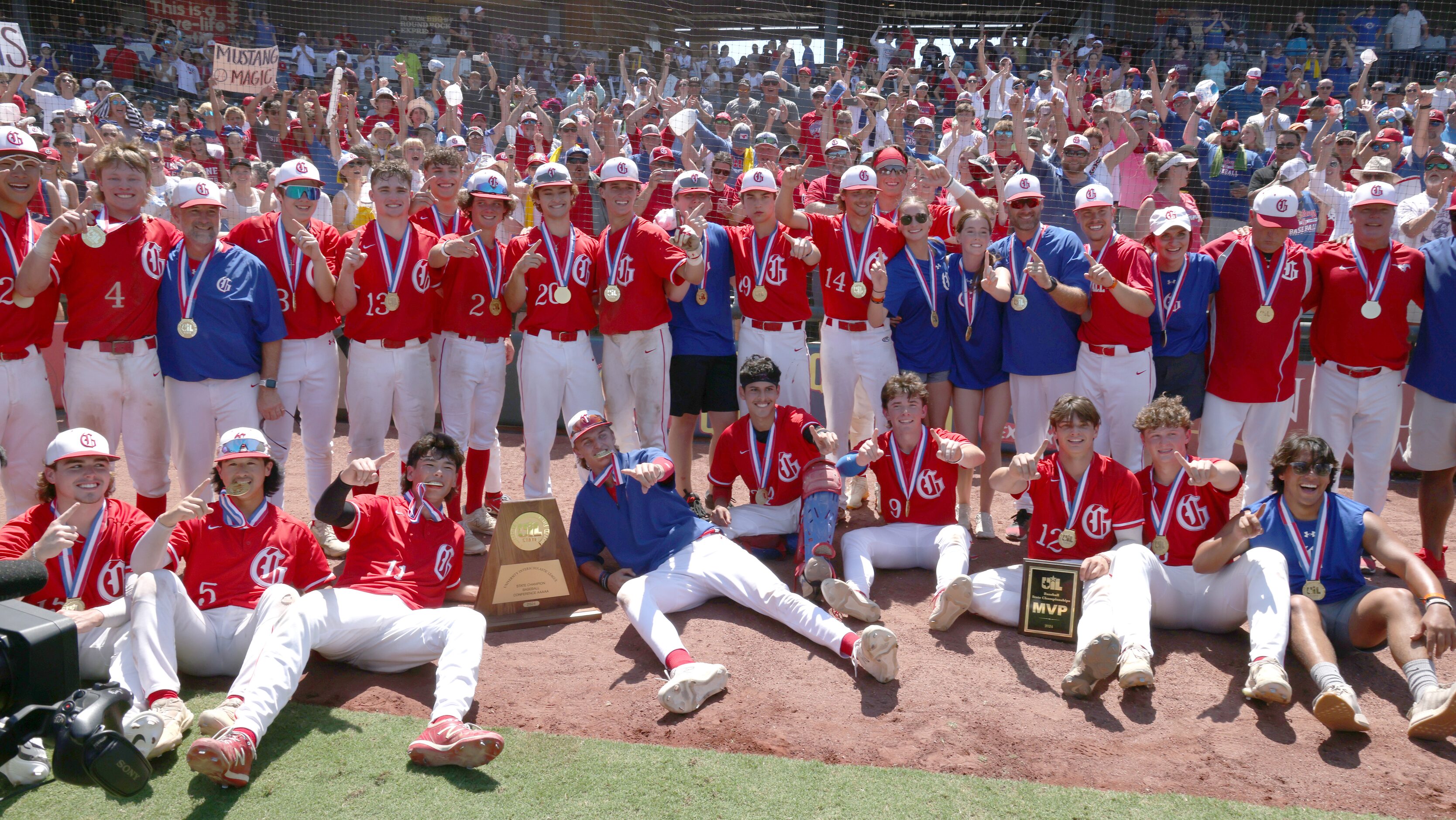 Grapevine players and coaches pose with their fans after their 6-5 victory over Lovejoy to...