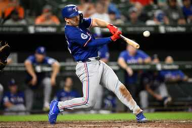 Texas Rangers' Wyatt Langford hits a three-run home run during the eighth inning of a...