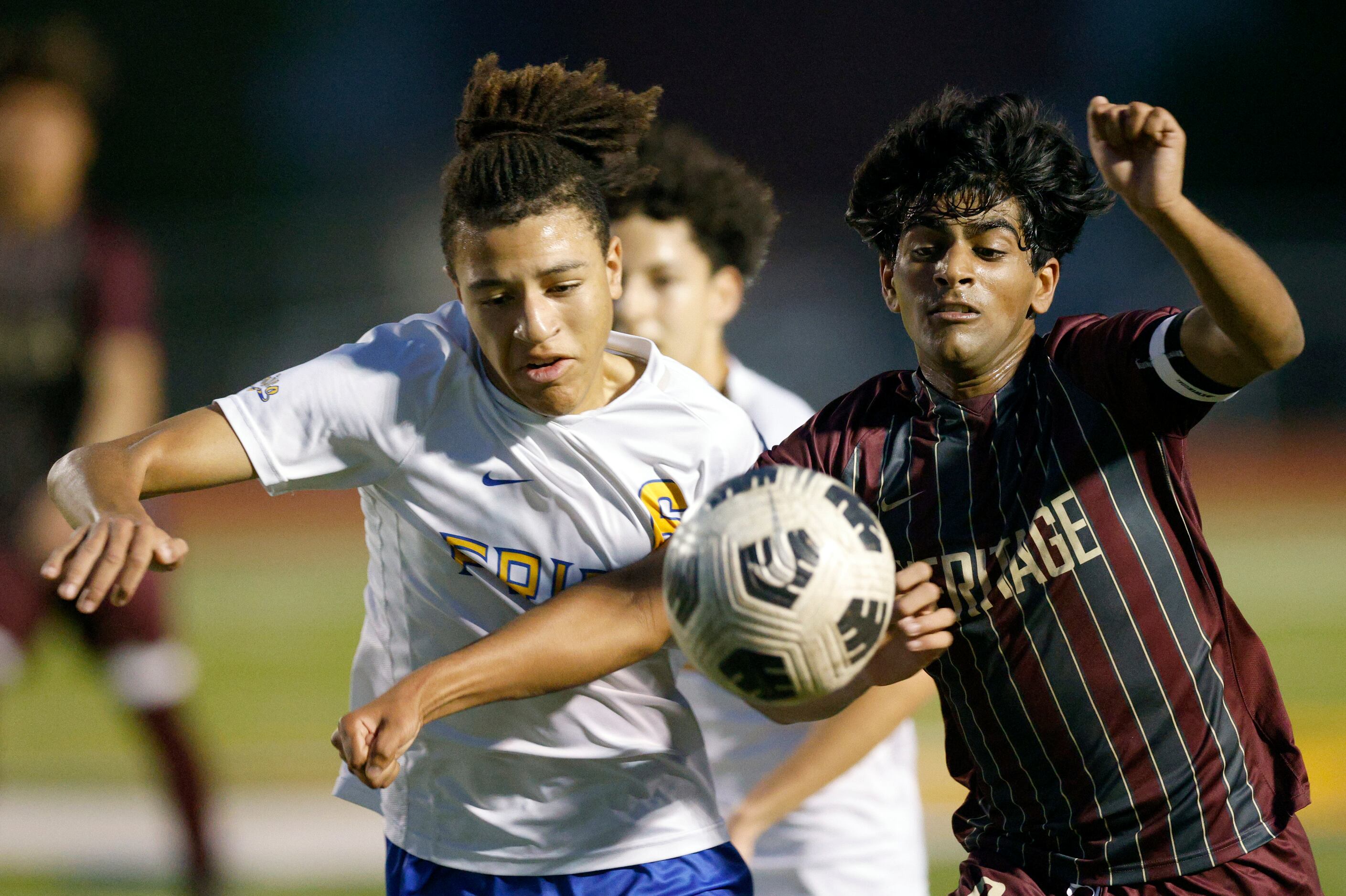 Frisco’s Yannis Banae (left) and Frisco Heritage defender Ziyaan Momin (2) battle for the...