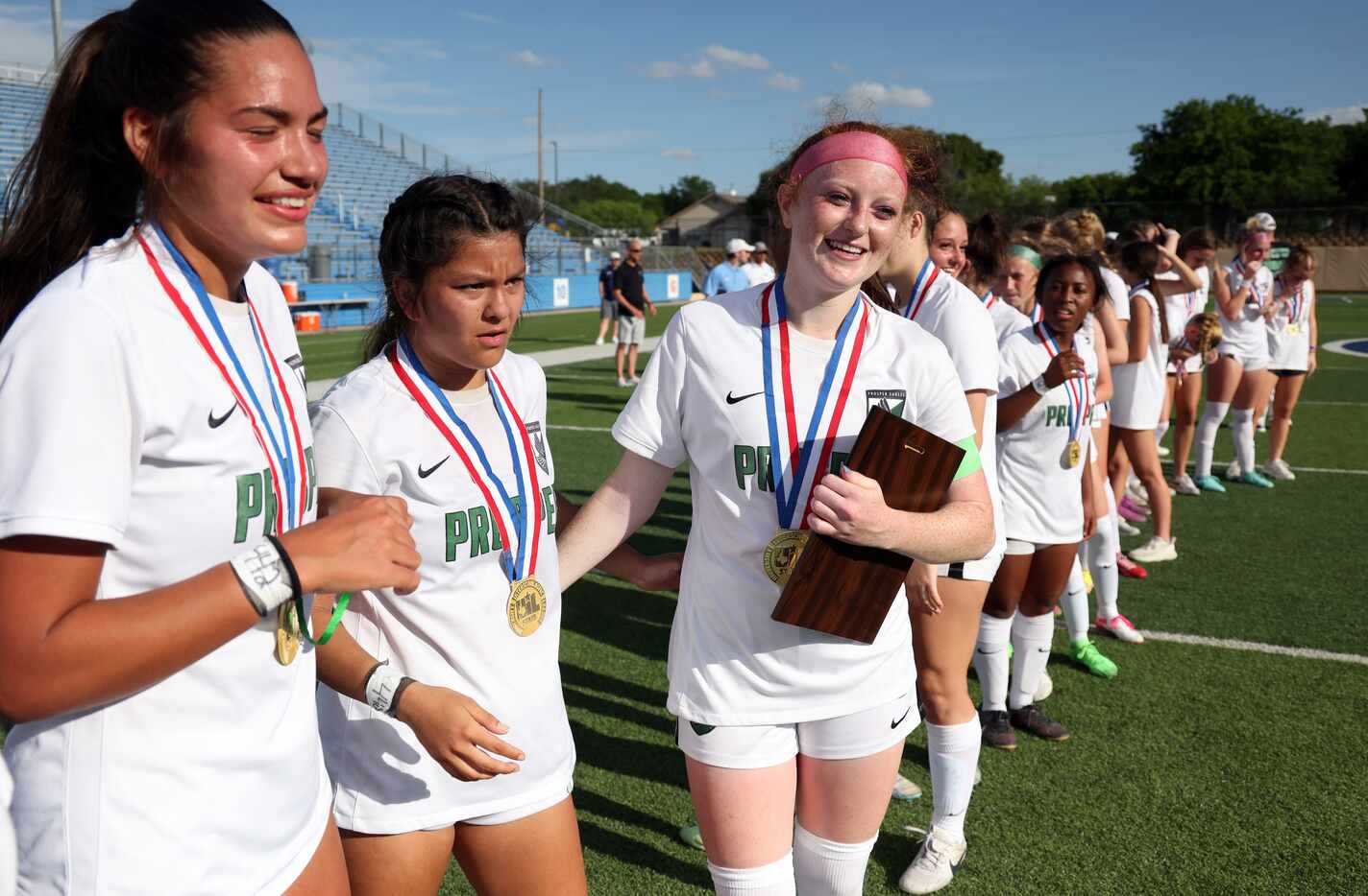  Prosper midfielder Olivia Hess (8), third from left, beams after being recognized as the...