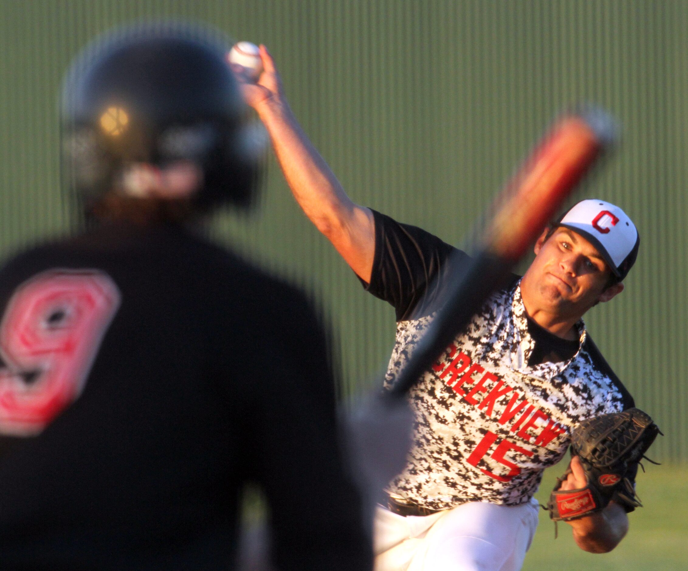 Carrollton Creekview pitcher Brandon White (15) delivers a pitch to a Dallas Hillcrest...