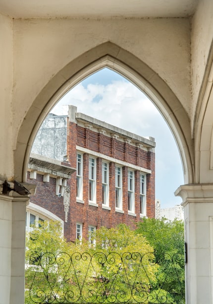 An archway on the 1920 Magnolia Oil/KLIF building frames the former Munger Cadillac showroom...