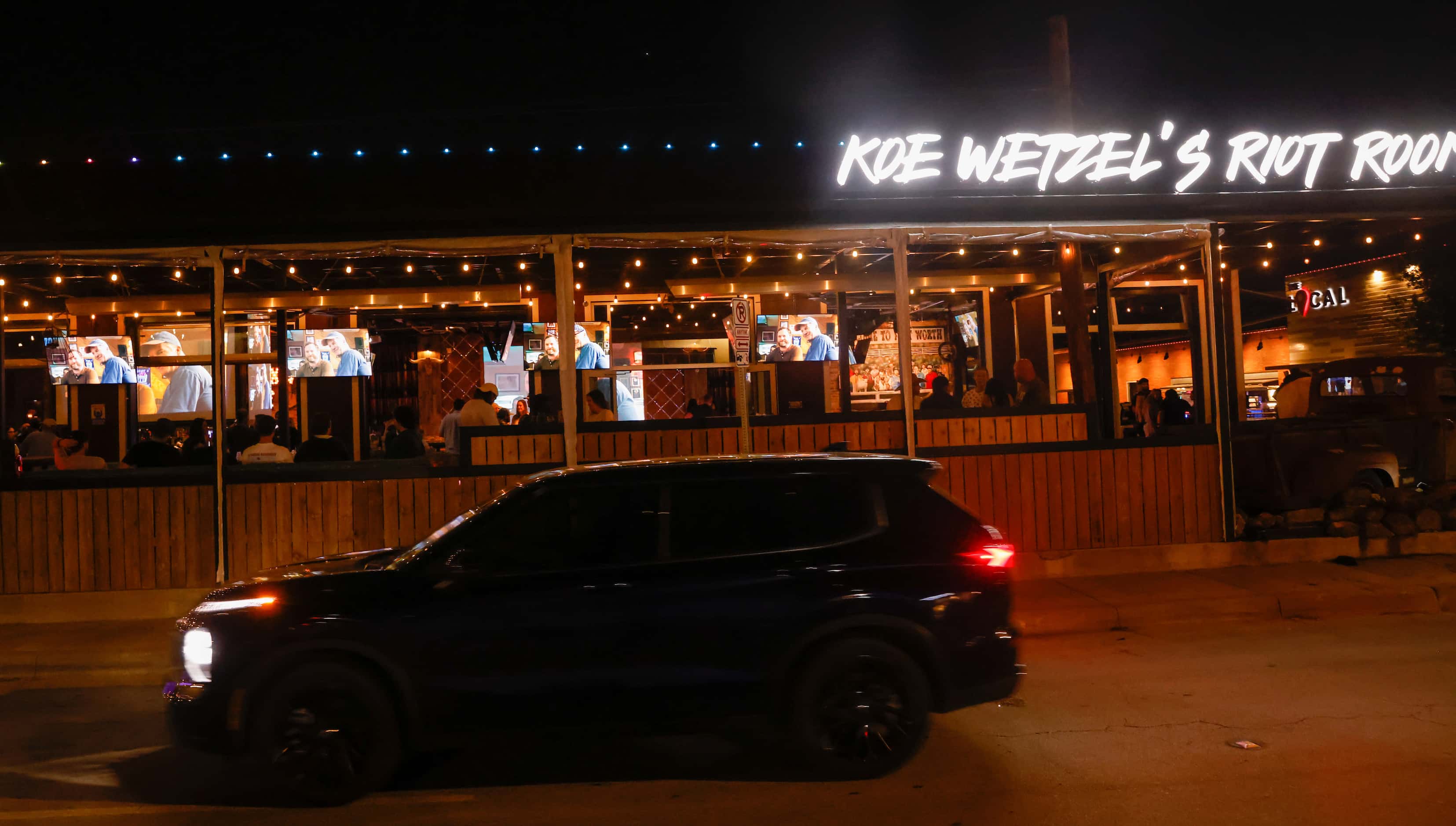 A car moves by Koe Wetzel’s Riot Room in Fort Worth along Foch Street on Thursday, March 23,...