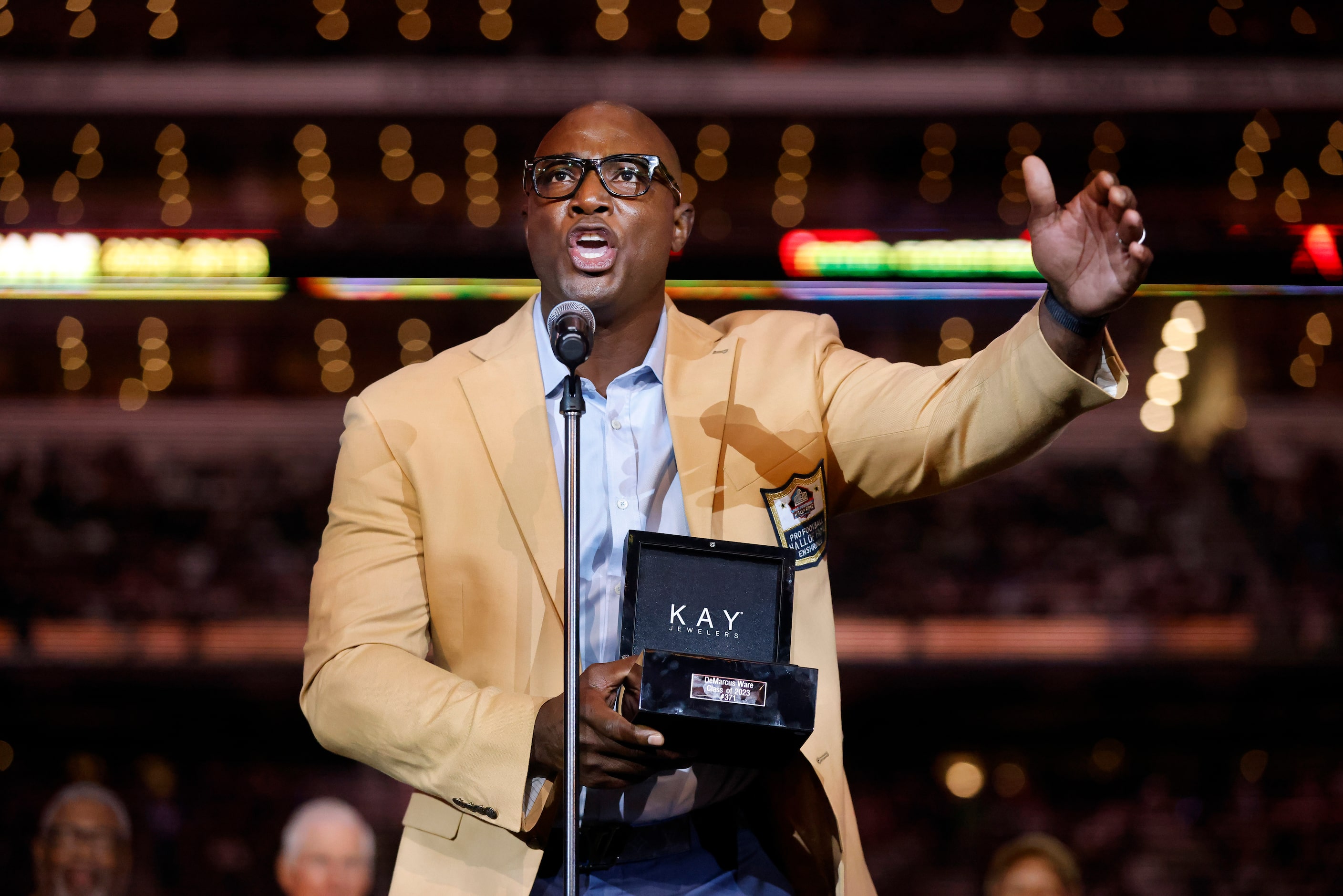 Dallas Cowboys Pro Football Hall of Famer DeMarcus Ware speaks to the crowd after e...