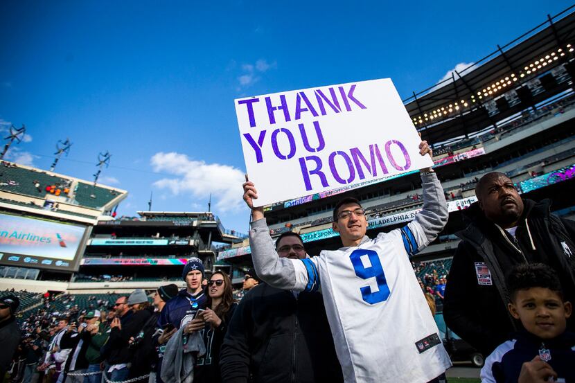 A fan holds a sign in support of Dallas Cowboys quarterback Tony Romo before an NFL football...