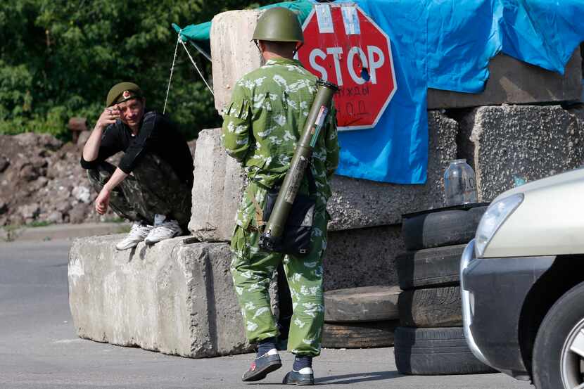 Pro-Russian fighters talk at a check-point near the city of Kramatorsk, Donetsk region,...