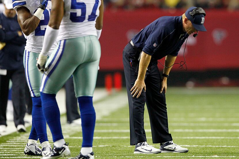 Dallas Cowboys head coach Jason Garrett bends over on the field as his team fails to stop...