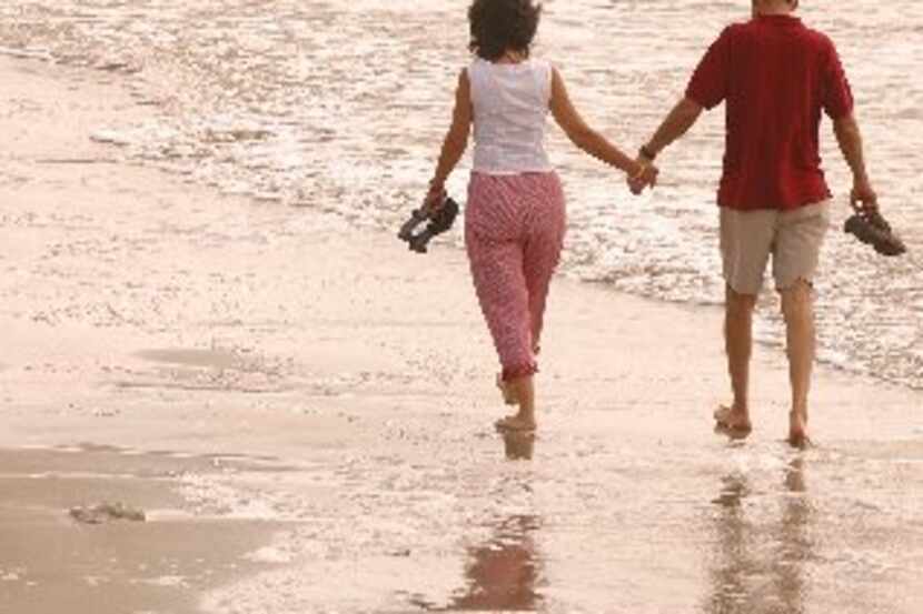 ORG XMIT: *S0408595060* GALVESTON - Lori and Steve Blow walk on beach along Galveston...
