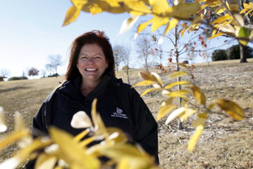 City forester Karen Woodard, at T&P Hill on White Rock Lake, says saplings are needed to...
